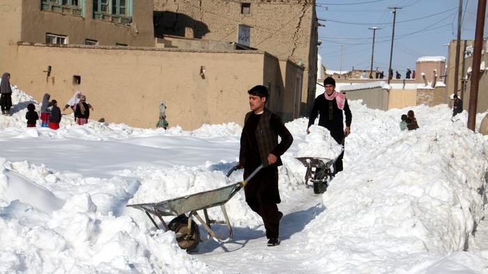 People remove snow from their house in Ghazni, Afghanistan, on Feb. 5, 2017.