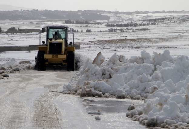 Local authorities clear a road blocked by snowfall in Tunisia on January 25, 2019