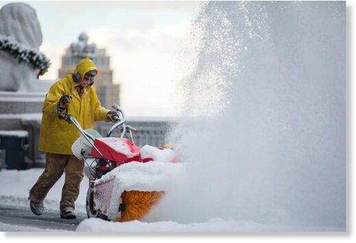 Workers clear snow at the Utah Capitol on Friday, Dec. 10, 2021