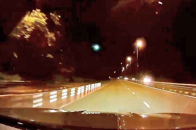 A rare astronomical phenomenon of a blazing fireball streak in the sky was seen on Thursday night. Photo shows a dashcam footage of the flashing bright green light along Jalan Kebangsaan. -