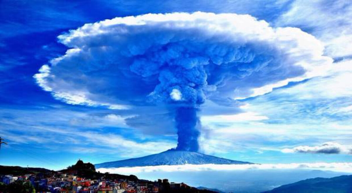 The 2015 Etna eruption. The most violent in 20 years.  The plume reaching the tropopause was blocked hence the characteristic anvil shape​