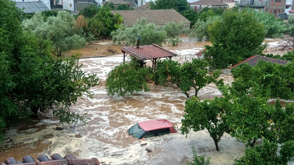 Floodwaters cover a car and the yards of houses in Milina village, Pilion region, central Greece, Tuesday, September 5, 2023.
