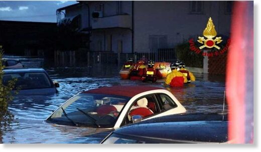 Italian firefighters work in flooded streets in the